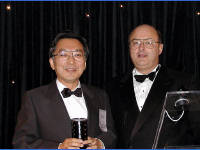 14-Oct-2002 21:11
Cannes
The Open Cannes Awards 
Carl Cargill presenting  The Un-Cannes-y Award to an individual for the most outstanding contribution to The Open Group based outside the US or Europe to Hirokazu Narita from Fujitsu.