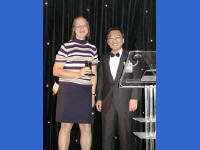 14-Oct-2002 21:15
Cannes
The Open Cannes Awards 
Hirokazu Narita staying on the podium to present  The Grand Cannes-yon Award for outstanding achievement in mandating a specification for procurement by Customer organization to 
NASA for the SEWP III program. The award is collected by Joanne Wojtek.